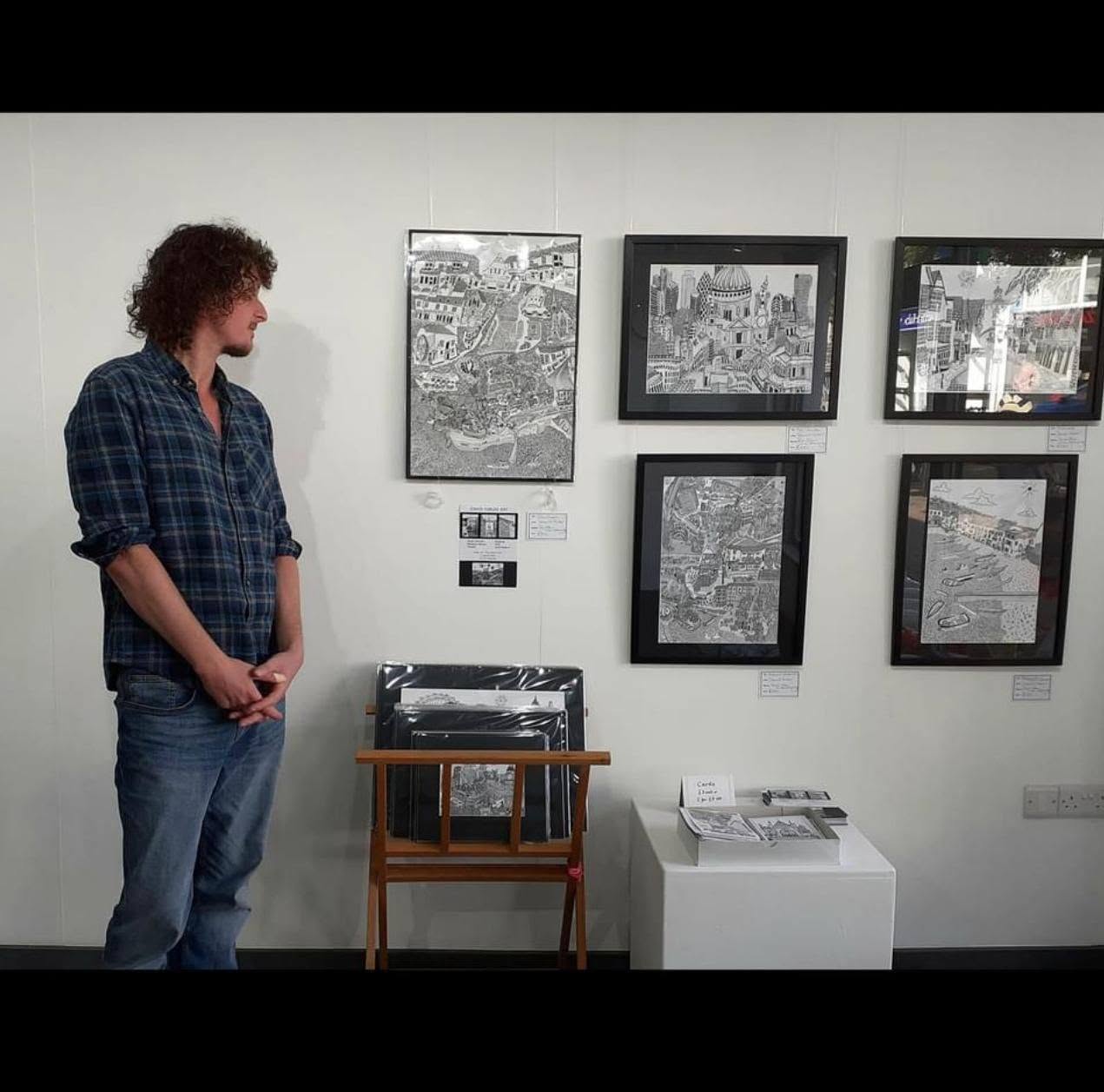 David Furler beside a display of his drawings